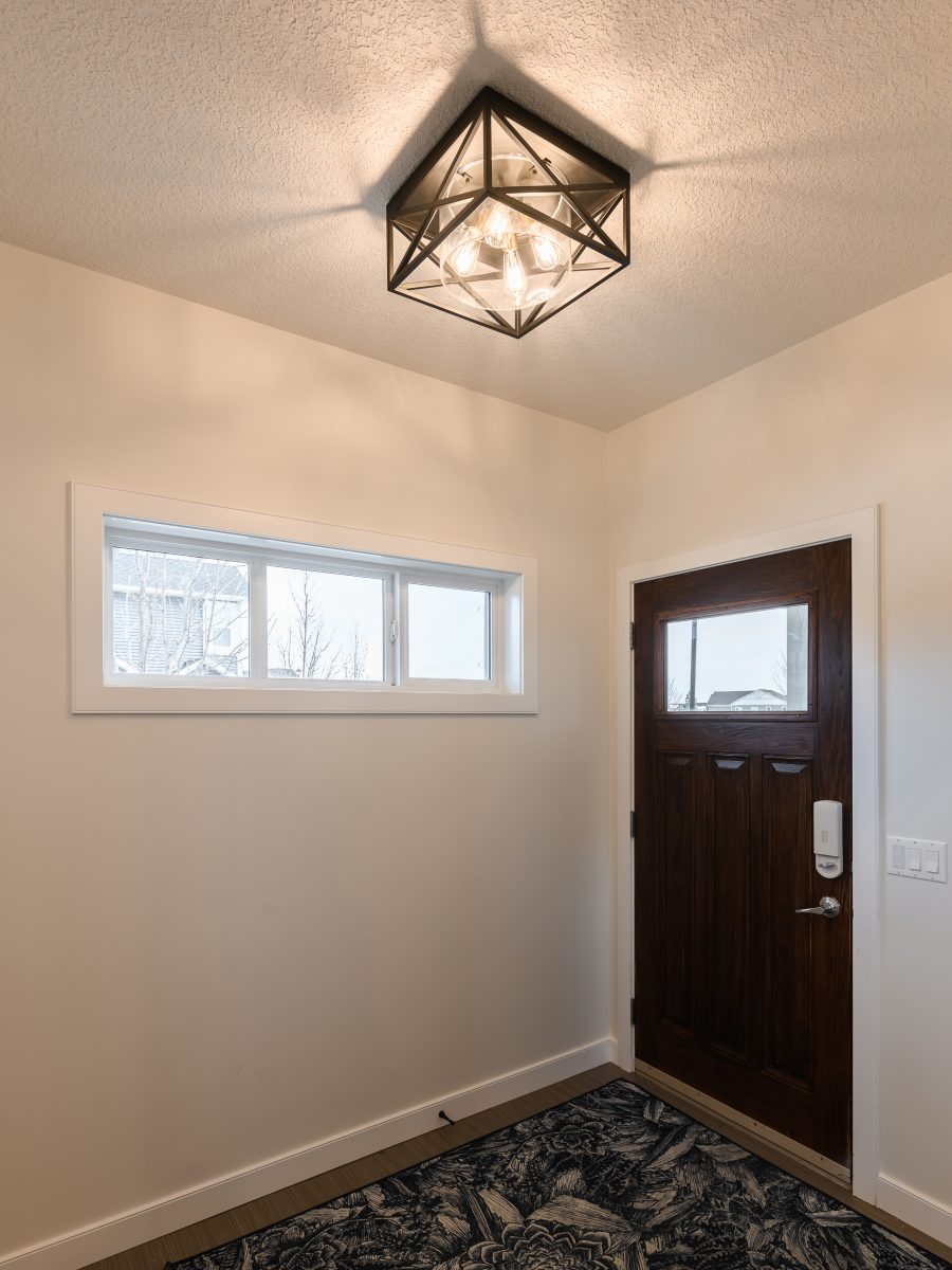 modern farmhouse style entryway with chandelier