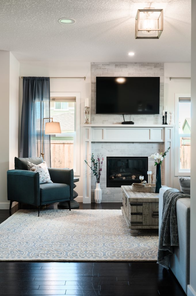 a modern farmhouse living room using blues, white stone tiles and neutrals
