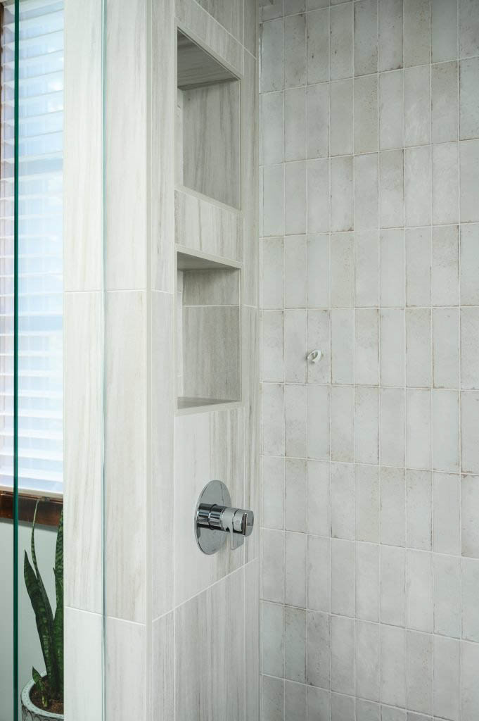 a modern standing shower designed with off-white tiling