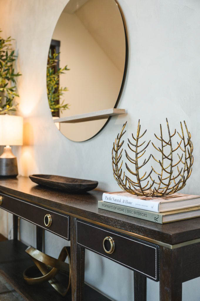 an large round mirror with no border to compliment the table and highlight the decor