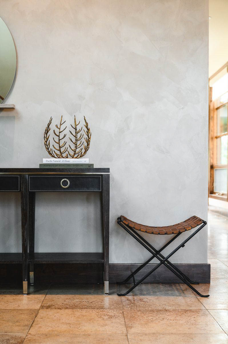 lime washed walls and a black table to contrast the grey and brown tones