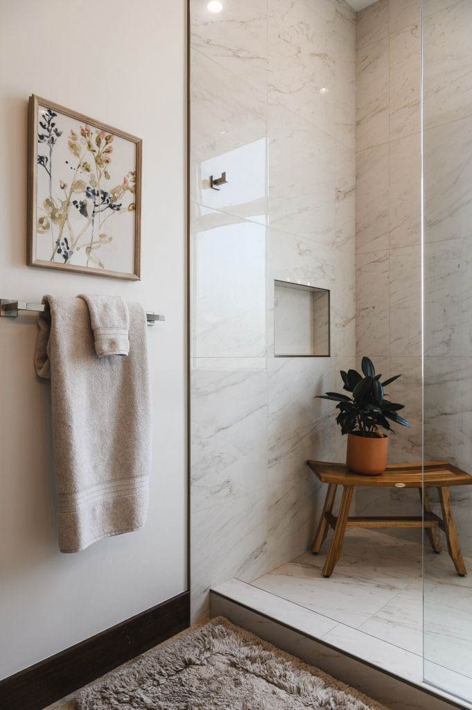 a spa-like oasis guest bathroom using calm neutrals, wood, marble and a plant