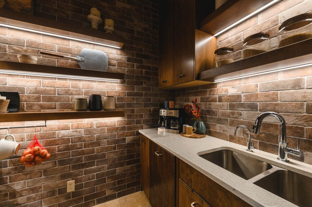 the lighting under the floating shelves creates an accent light for those who don't like the big light