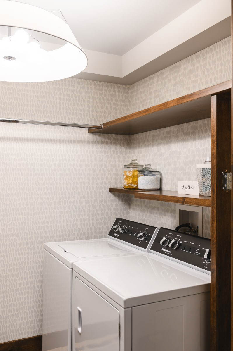 a larger light for proper lighting overhead, wall to wall patterned wallpaper to bring the space to life