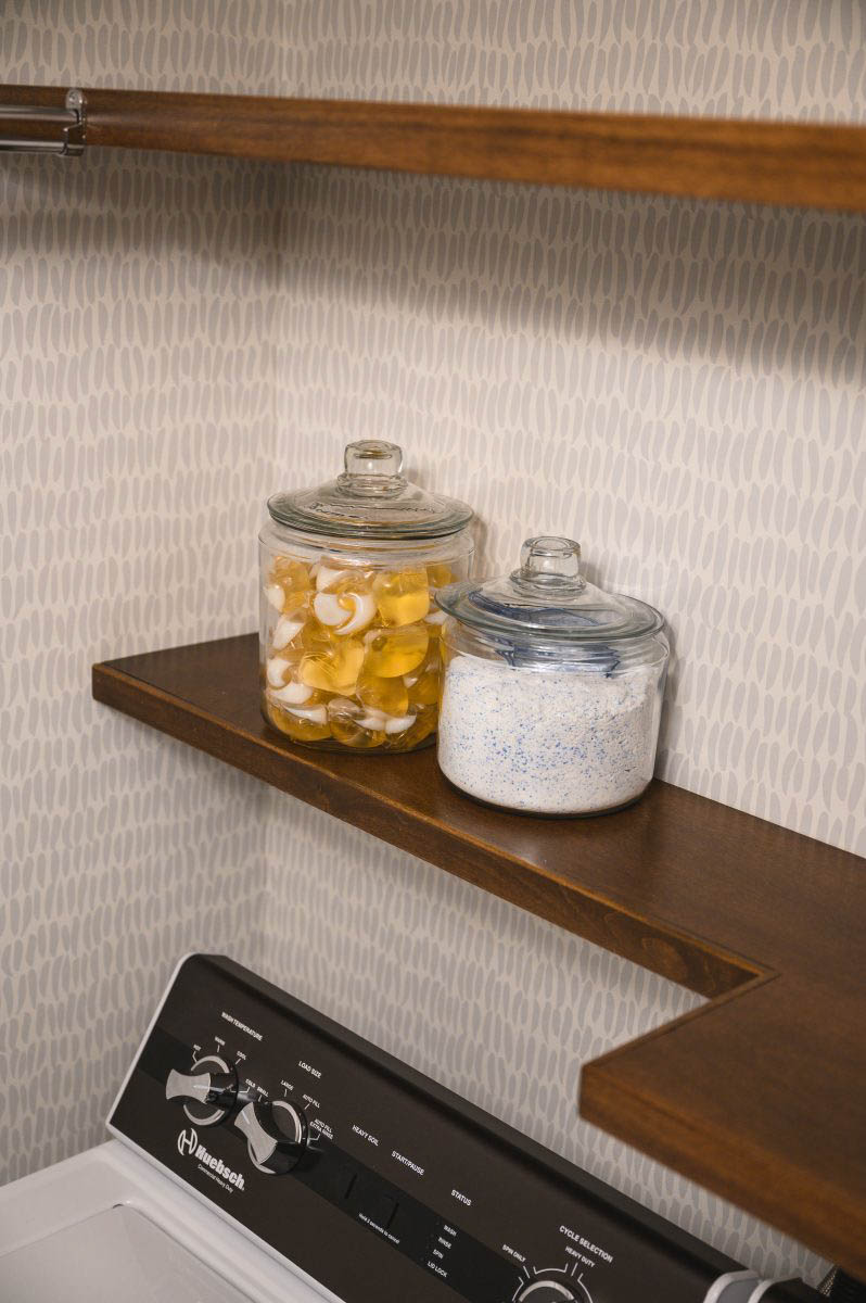 laundry room styled with functional containers for detergent, and looks beautiful