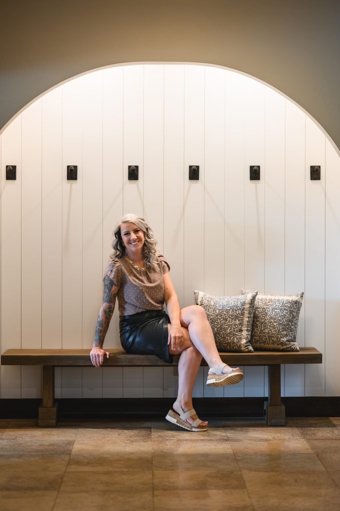 mud room niche in basement with arch and shiplap with interior design sarah kirkpatrick of unshelf design