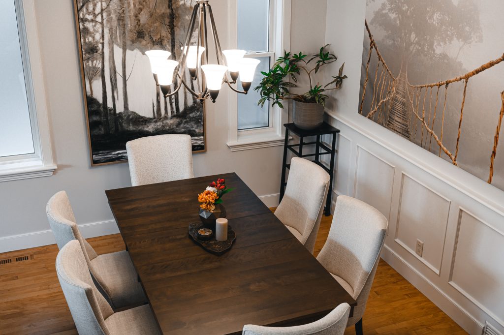 Cozy luxury killarney home interior decorating Dining Room wainscotting unshelf design. Dining room with off-white wainscoting detail under a large art piece.