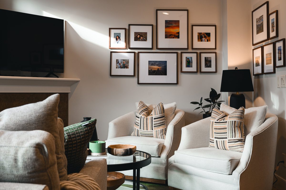 Cozy natural killarney home interior decorating Living Room gallery wall unshelf design. Sunlight beaming onto a black and white photo gallery wall.