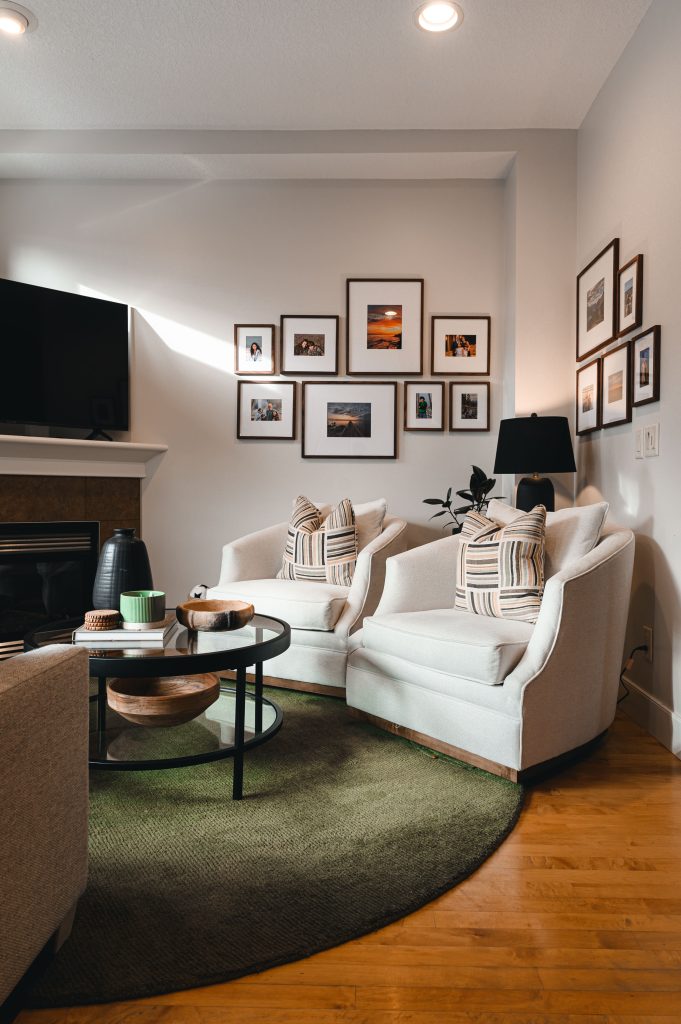 Cozy luxury killarney home interior decorating Living Room green area rug unshelf design. Cozy living room with natural sunlight and warm wood tones.