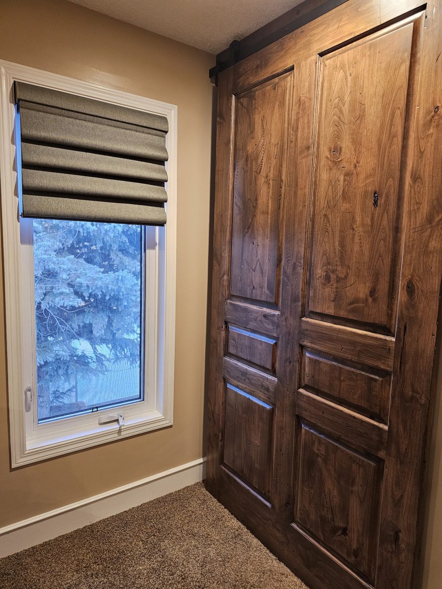 heavily aged barn door with green hunter douglas window treatments