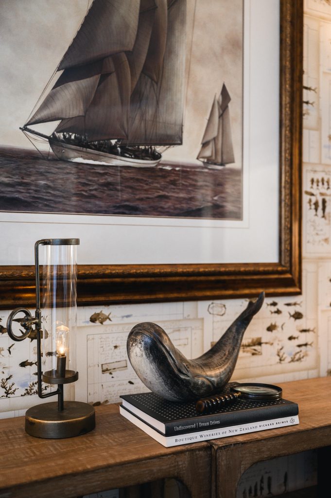 Tuscany Estate Interior Decorating Living Room Feature Artwork Unshelf Design. Whale sculpture on top of books sitting on a wood table.