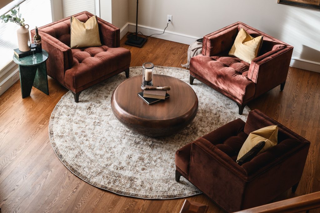 Tuscany Estate Interior Decorating Sitting Room Open Unshelf Design. Warmed toned hardwood floors with cozy area rug.