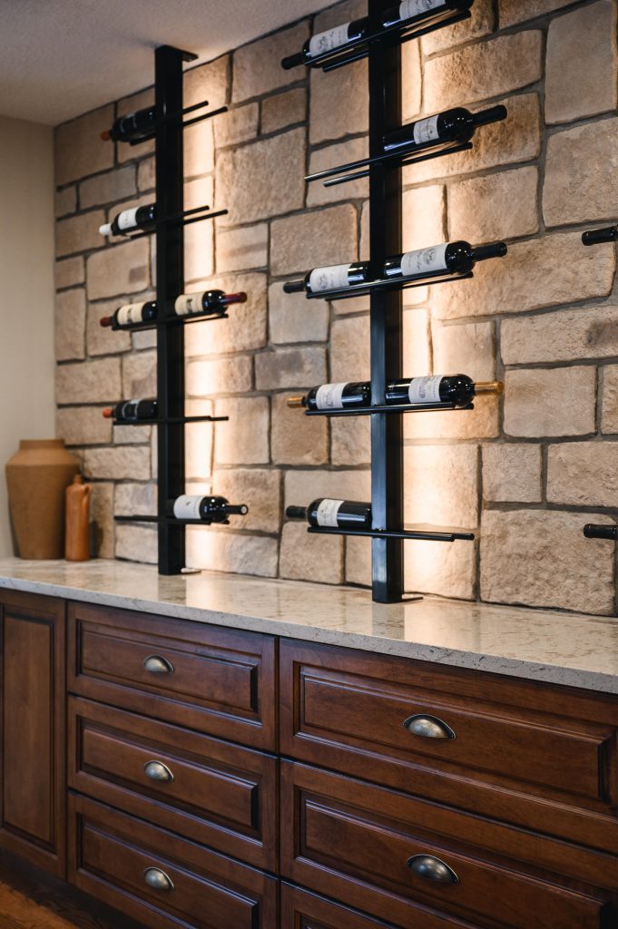 Tuscany Estate Interior Decorating Wine Tasting Room Illuminated Shelves Unshelf Design. Wine shelves built on a rustic stone wall.