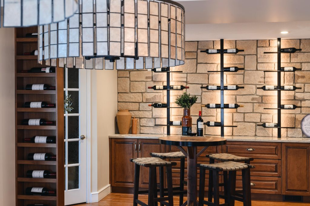 Tuscany Estate Interior Decorating Wine Tasting Room Wine Storage Room Unshelf Design. Black and off-white textured chandelier.