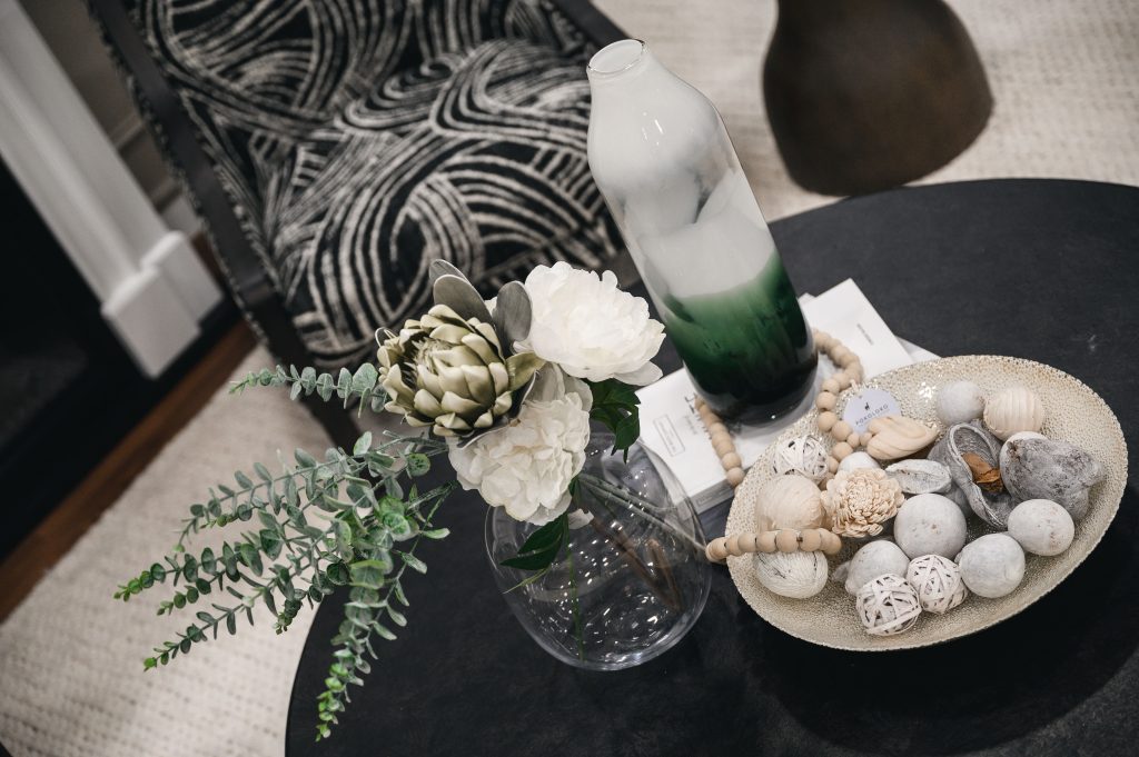Renovation Show Stately Room Interior Decorating Stately Details of Coffee Table Unshelf Design. Black coffee table styled with a modern glass vase with flowers.