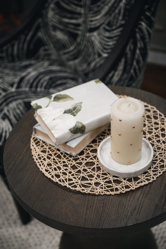 Renovation Show Stately Room Interior Decorating Stately Details of End Table Unshelf Design. Side table styled with a candle and books.
