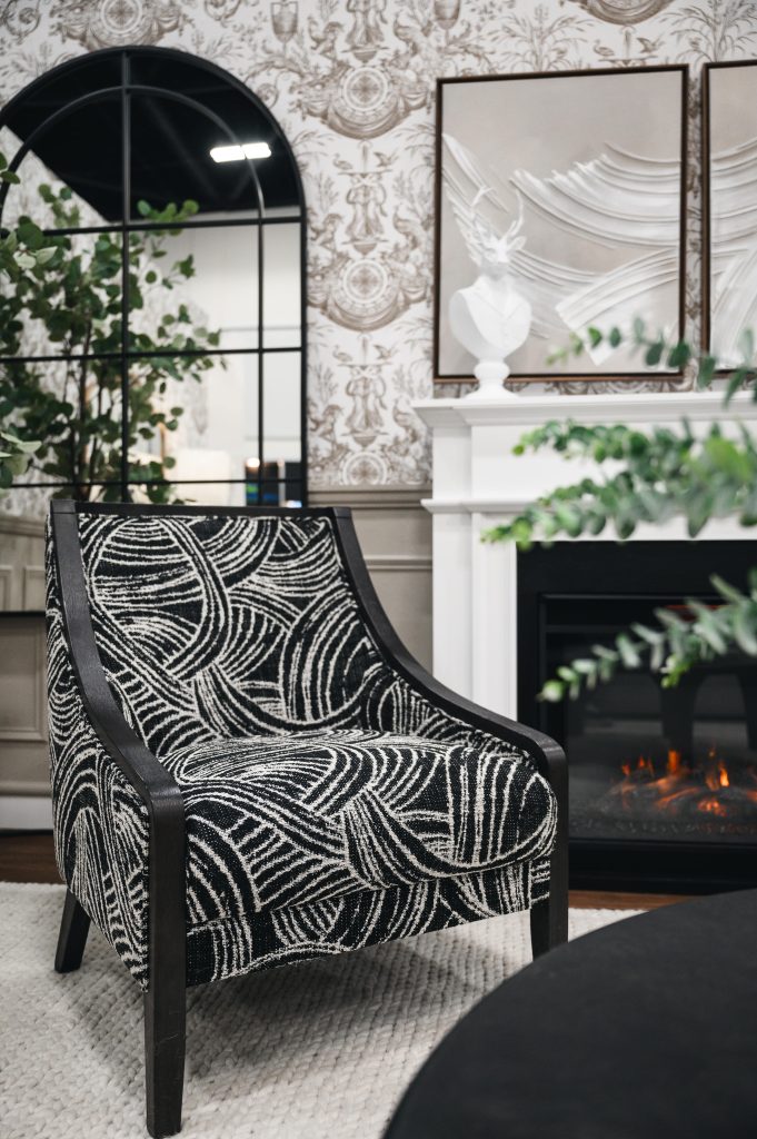 Renovation Show Stately Room Interior Decorating Stately Living Room Modern Wallpaper Unshelf Design. Black and white accent chair in front of a fireplace.