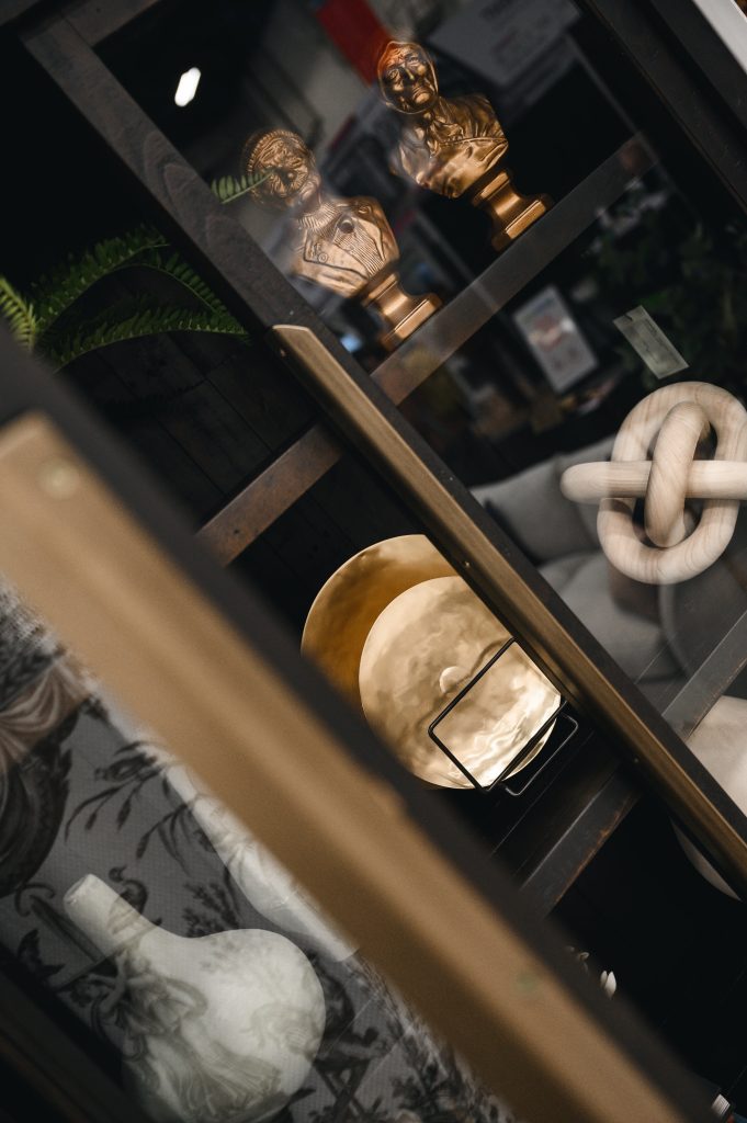 Renovation Show Stately Room Interior Decorating Stately Shelfie Unshelf Design. Details of a dark wood bookcase.