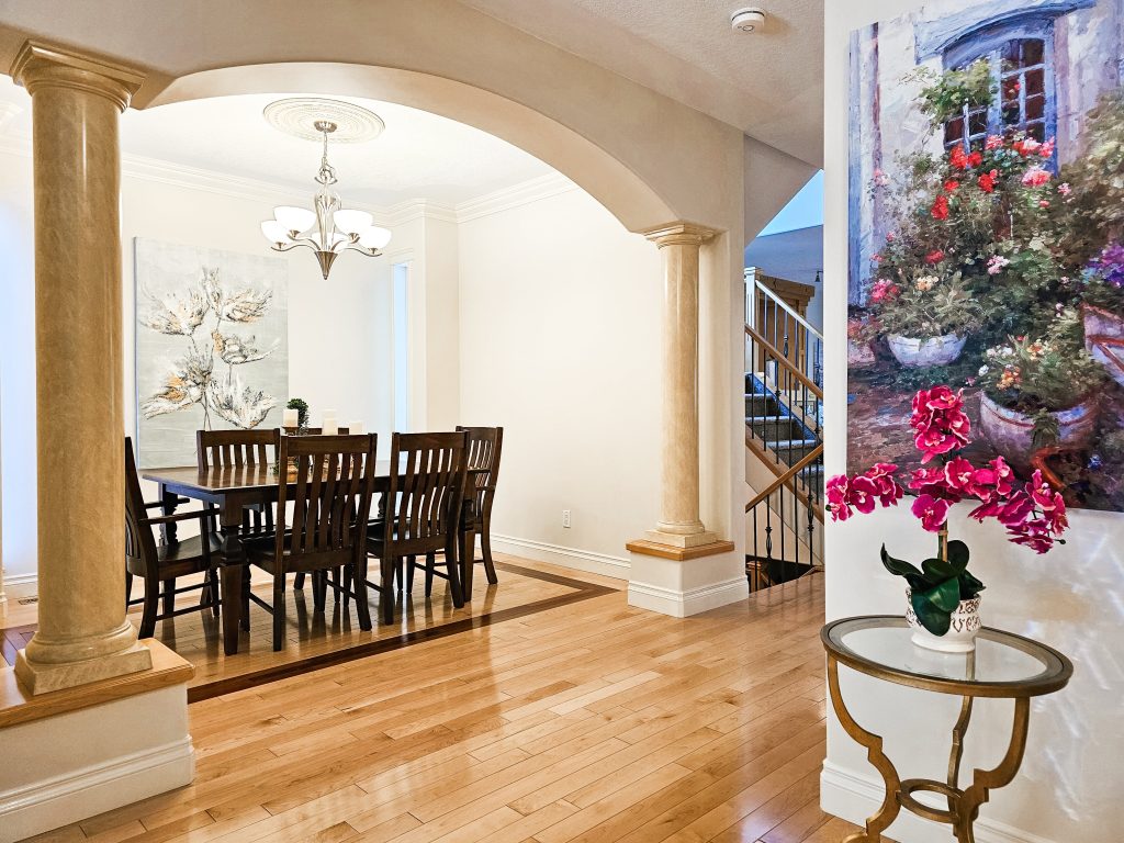 Transitional Inglewood Home Home Staging Dining Room with Entry Flowers Unshelf Design. Small brass end table in entry way with pink flowers.