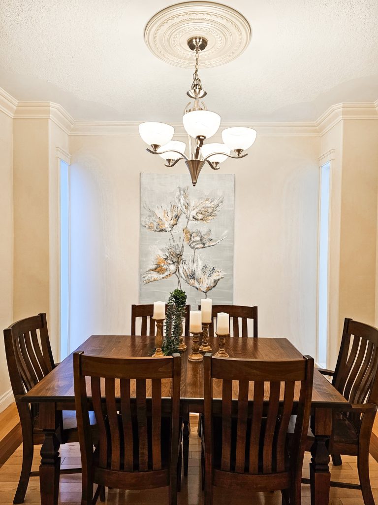 Transitional Inglewood Home Home Staging Dining Room Unshelf Design. Large wood dining table with candle decor.