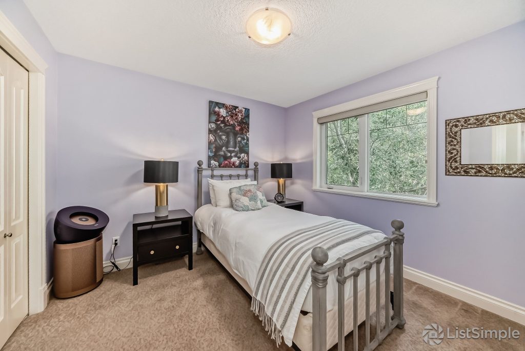 Transitional Inglewood Home Home Staging Guest Bedroom 2 Unshelf Design. Modern gold and black table lamps sitting on dark wood nightstand tables.