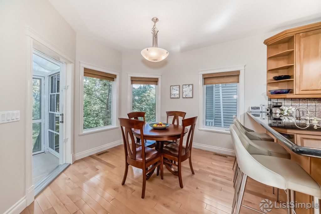 Transitional Inglewood Home Home Staging Kitchen and Breakfast Nook Chandelier Unshelf Design. Breakfast nook with a circular wood table and wood dining chairs.