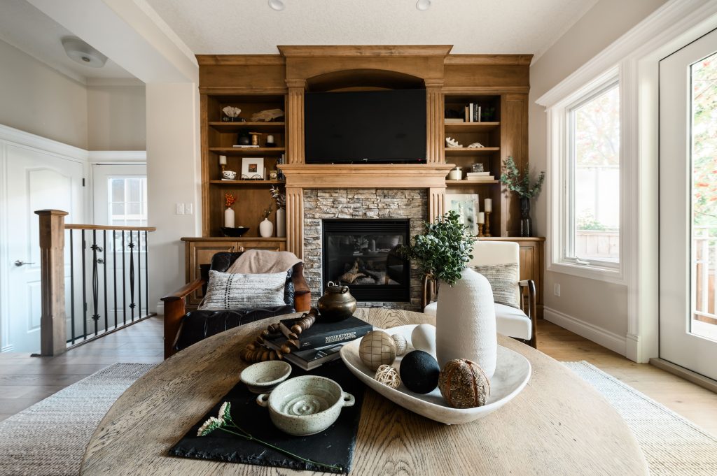 a living room styled with dark burnt orange, brown and gorgeous artwork