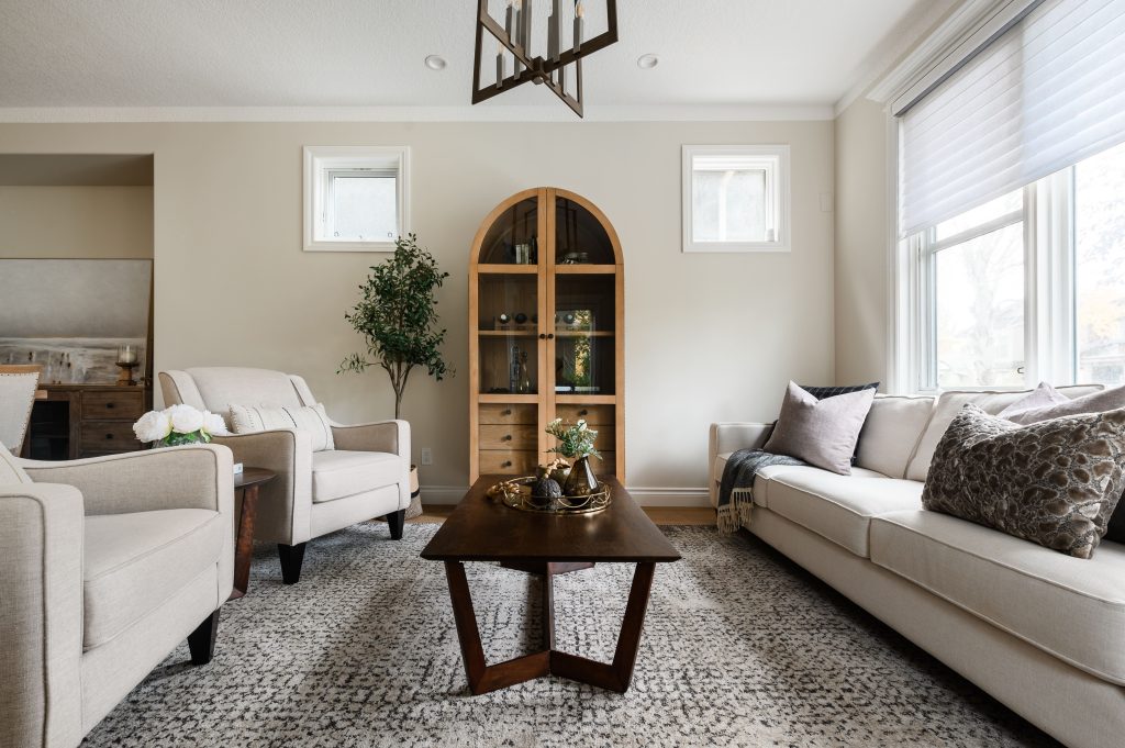 a living room styled with dark burnt orange, brown and gorgeous artwork
