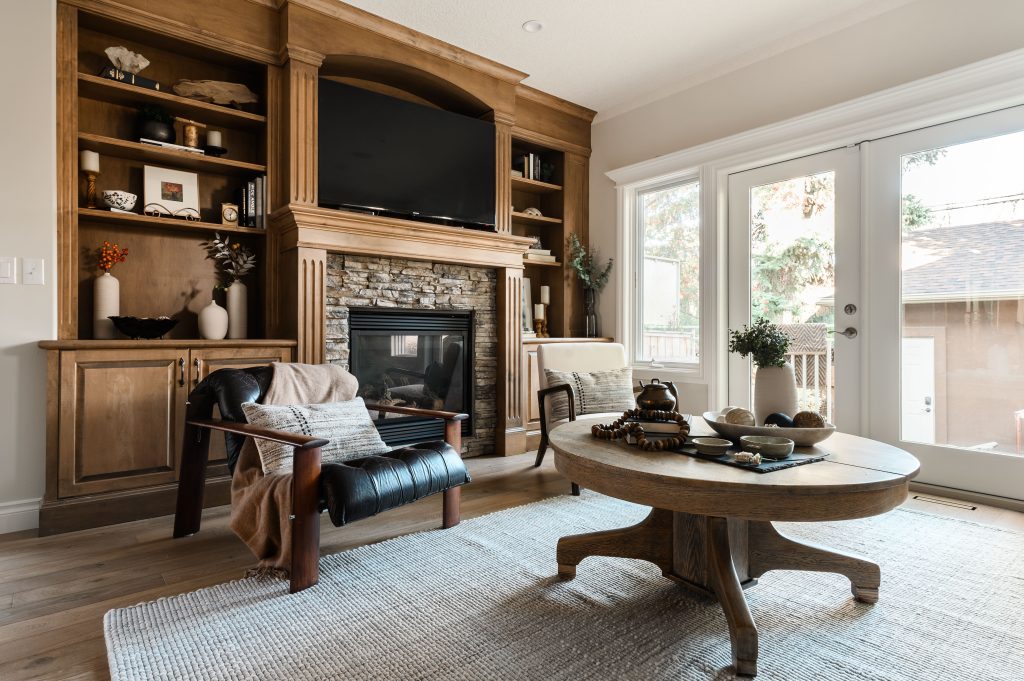 a living room styled with dark burnt orange, brown and gorgeous artwork