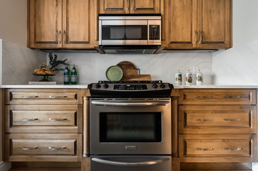 a bright modern kitchen with gorgeous tiled flooring to reflect the natural light. staged with a shimmering vase and sage
