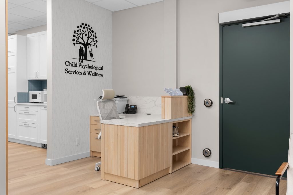 Psychology clinic commercial decorating front desk by Unshelf Design. Bright children's psychology clinic front desk.