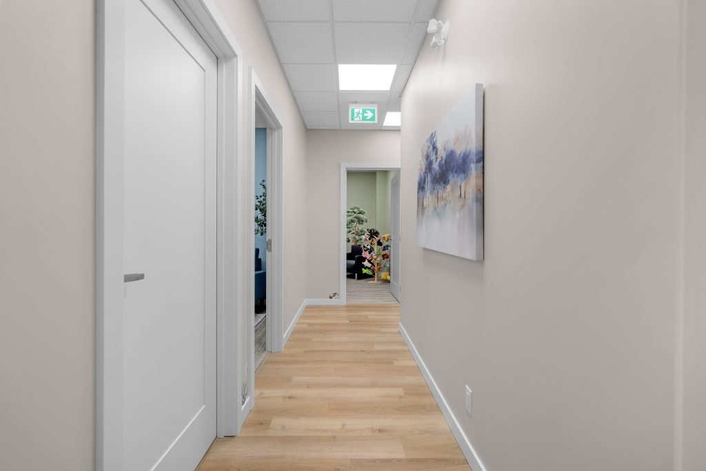 Psychology clinic commercial decorating hallway by Unshelf Design. Hallway of children's psychology clinic leads to playrooms.