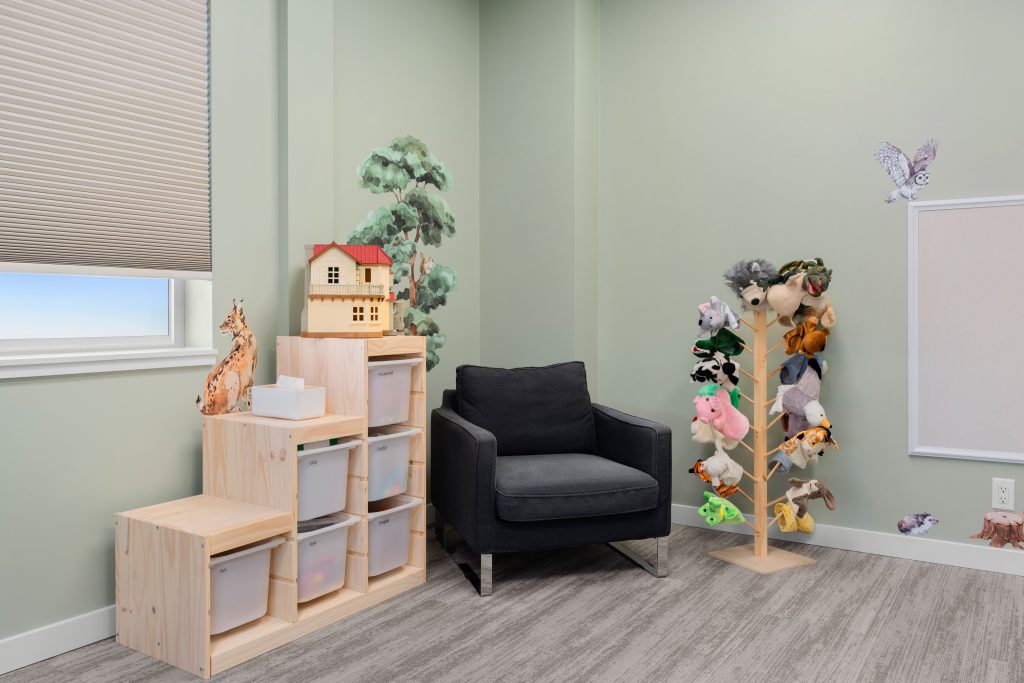 Psychology clinic commercial decorating jungle playroom puppets by Unshelf Design. Children's psychology playroom with animal hand puppets.