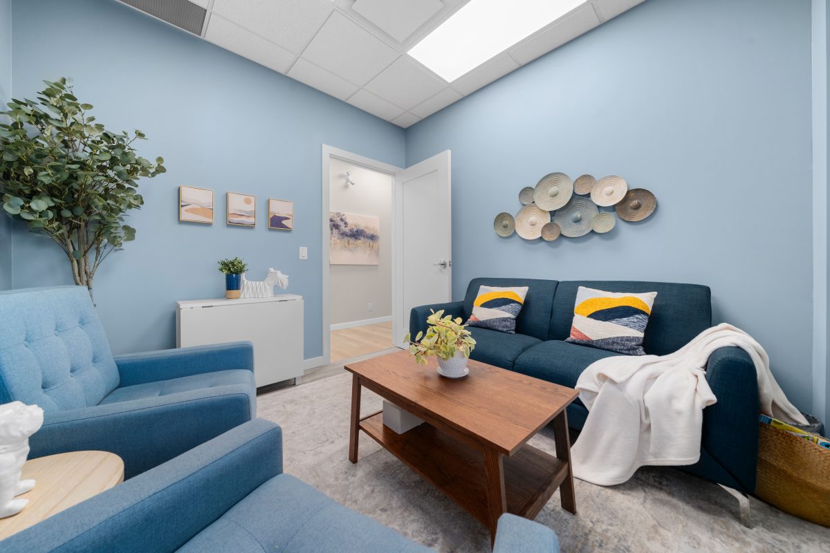 Psychology clinic commercial decorating relaxing light blue office Unshelf Design. Blue office with navy couch and blue chairs.