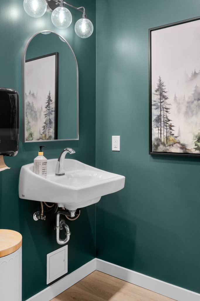 Psychology clinic commercial decorating teal powder room Unshelf Design. Bathroom decor with teal paint.