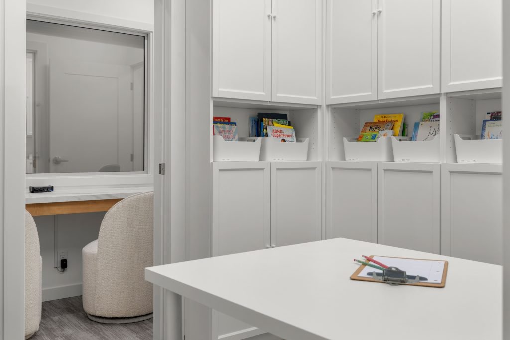 Psychology clinic commercial decorating testing room Unshelf Design. Testing room with shelf storage for books.
