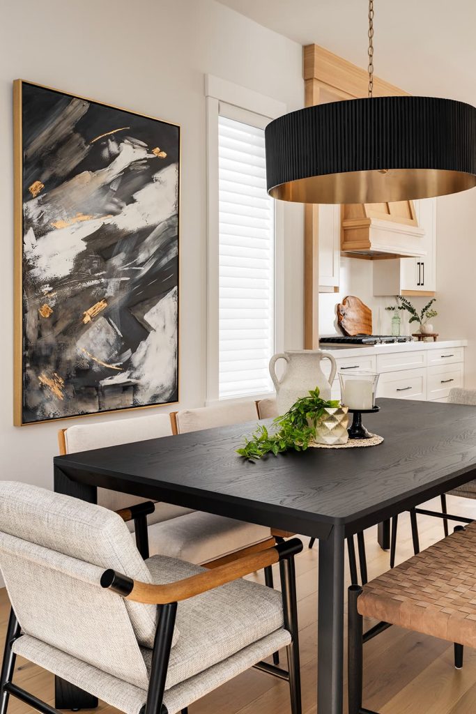 modern calgary kitchen with beautiful glass lighting fixtures, simple artwork and island chairs to match the cabinetry