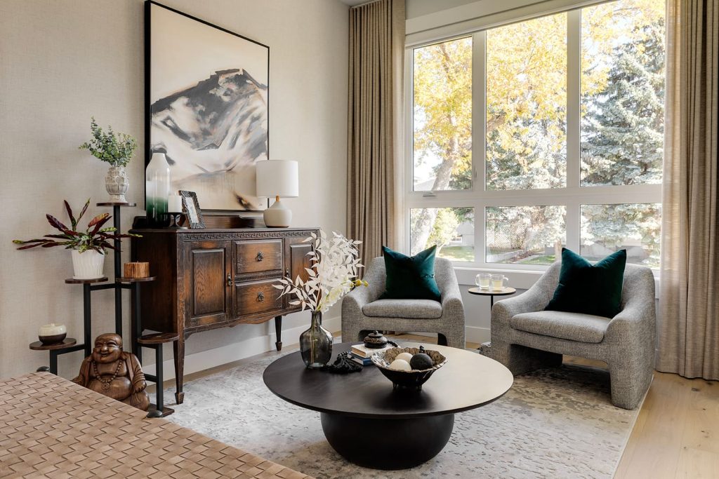 Seating area with matching grey chairs with teal pillows. Modern mountain design interior furnishing & decorating modern sitting room seating area Unshelf Design