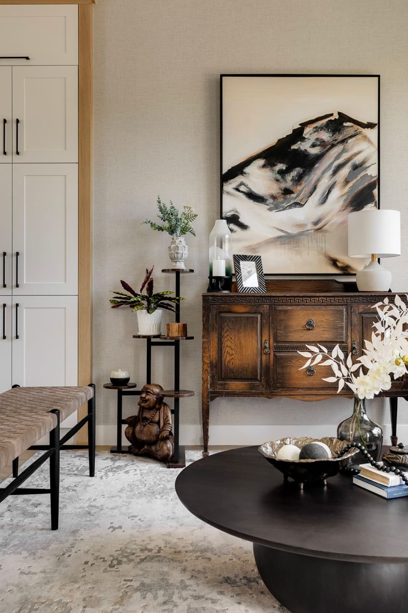 Dark wood cabinet in background, with round coffee table in foreground. Modern mountain design interior furnishing & decorating modern sitting room Unshelf Design