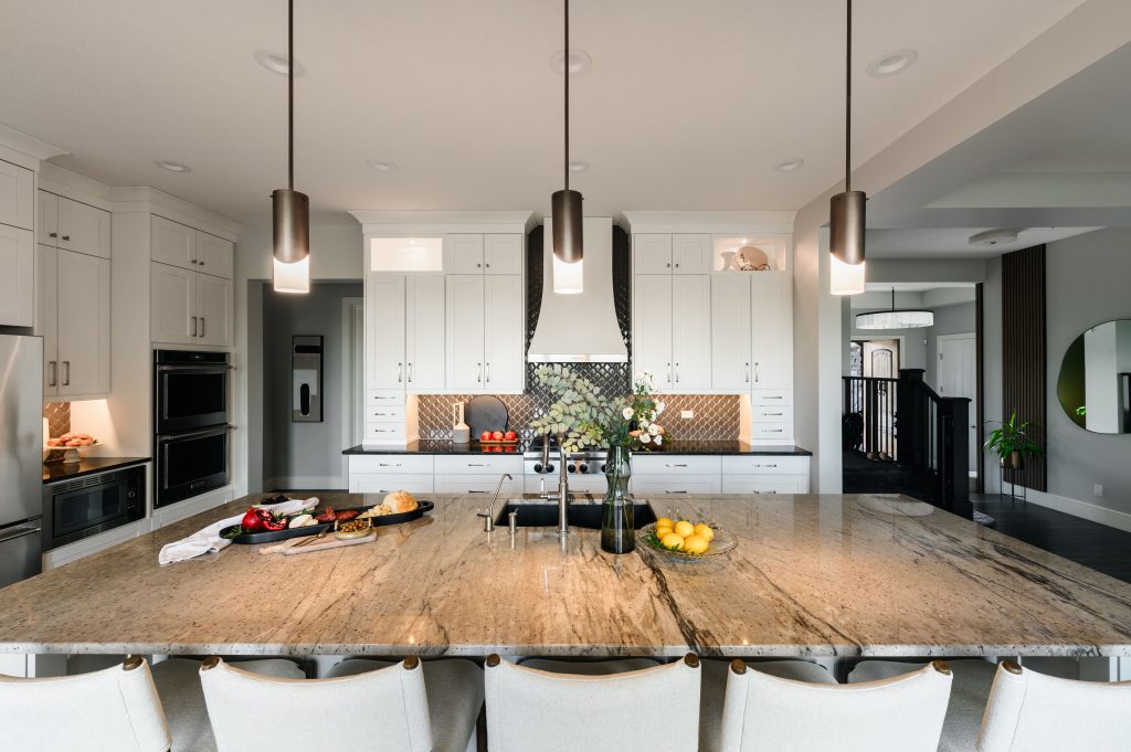 a bright modern kitchen with gorgeous tiled flooring to reflect the natural light. staged with a shimmering vase and sage