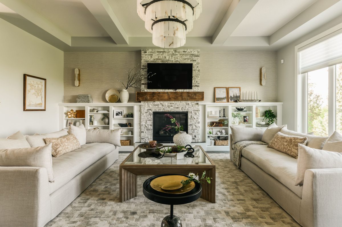 A master bathroom with a masasive standing shower with seating area styled with a lavender plant and a large bathtub styled with a shell, wood and plants