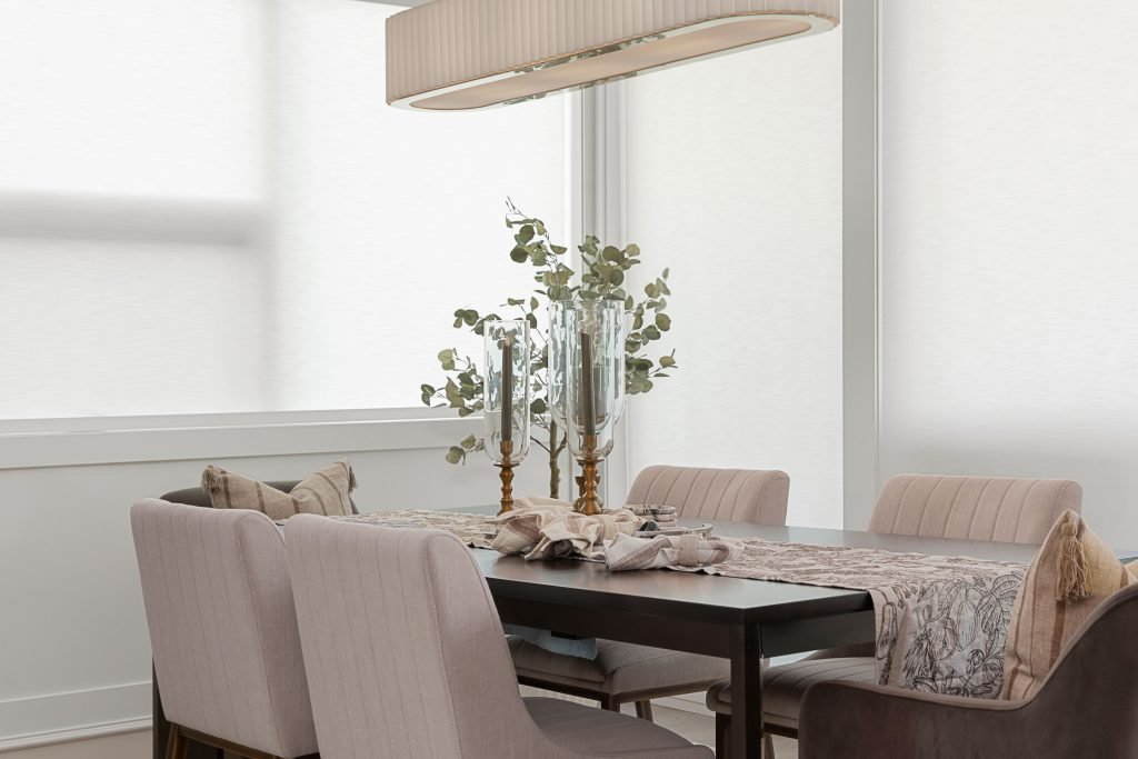 modern calgary kitchen with beautiful glass lighting fixtures, simple artwork and island chairs to match the cabinetry
