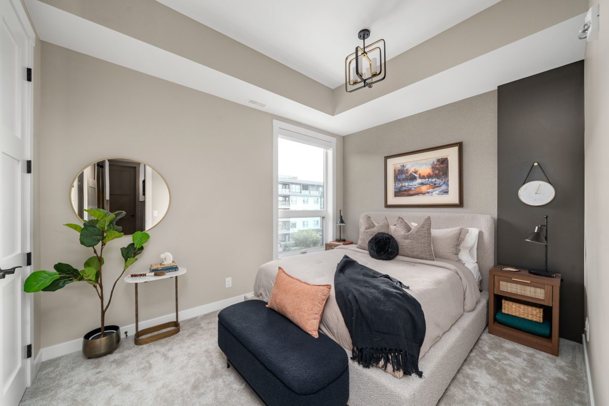 this bedroom had the furniture in it already, which was styled with minmal plant decor and a white duvet cover and pillows