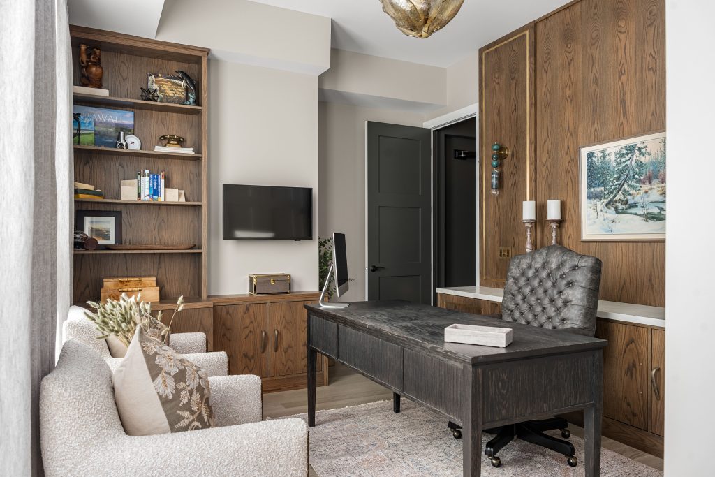 a living room styled with dark burnt orange, brown and gorgeous artwork