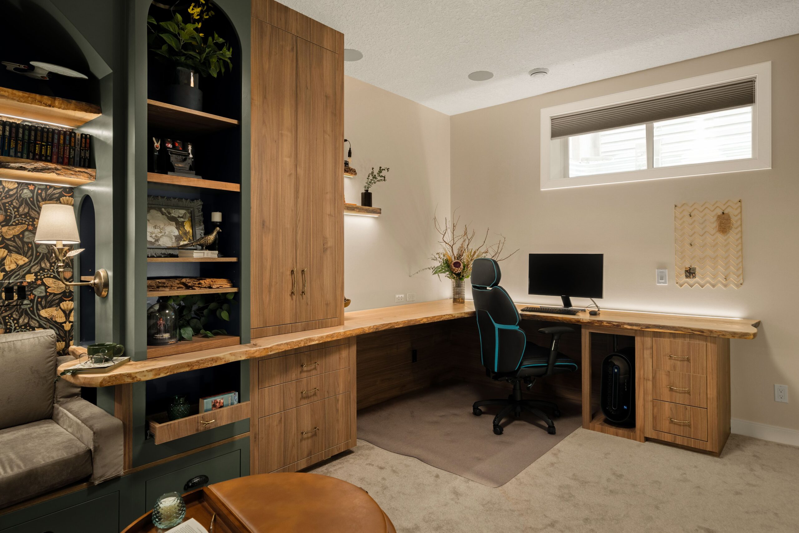 A live edge L-shaped wood home office desk with a gaming chair, and matching live edge floating shelves.